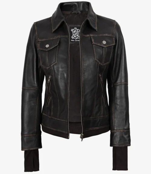 Brown leather jacket with dark brown stitching, featuring a zipper closure. It has a collared neck, two chest pockets with button flaps, and ribbed cuffs.