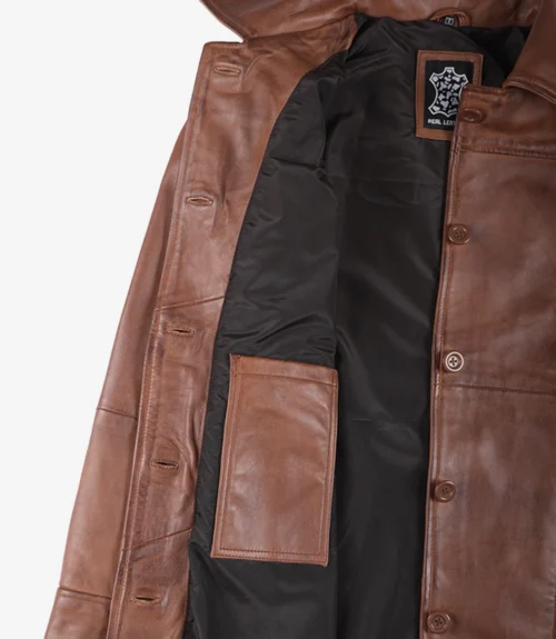 Open brown leather coat with a black interior lining and visible pocket. A rectangular label reads Real Leather. The image conveys a sense of style and durability.