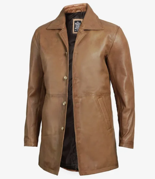 Brown leather trench coat with a front button closure and notched collar, displayed on a mannequin against a white background. The coat has side pockets and a dark interior lining.