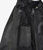 Open black leather jacket showing the inner lining with a label near the collar and an inner pocket. Zipper and button details are visible.