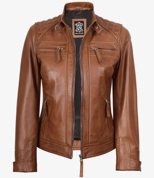 A brown leather jacket with quilted shoulder detailing and a stand-up collar is shown. It has multiple zipped pockets, exuding a classic, stylish vibe.